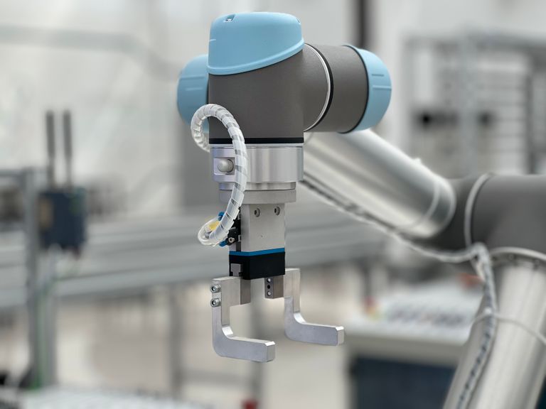 Brazo robótico colaborativo de precisión en entorno industrial moderno